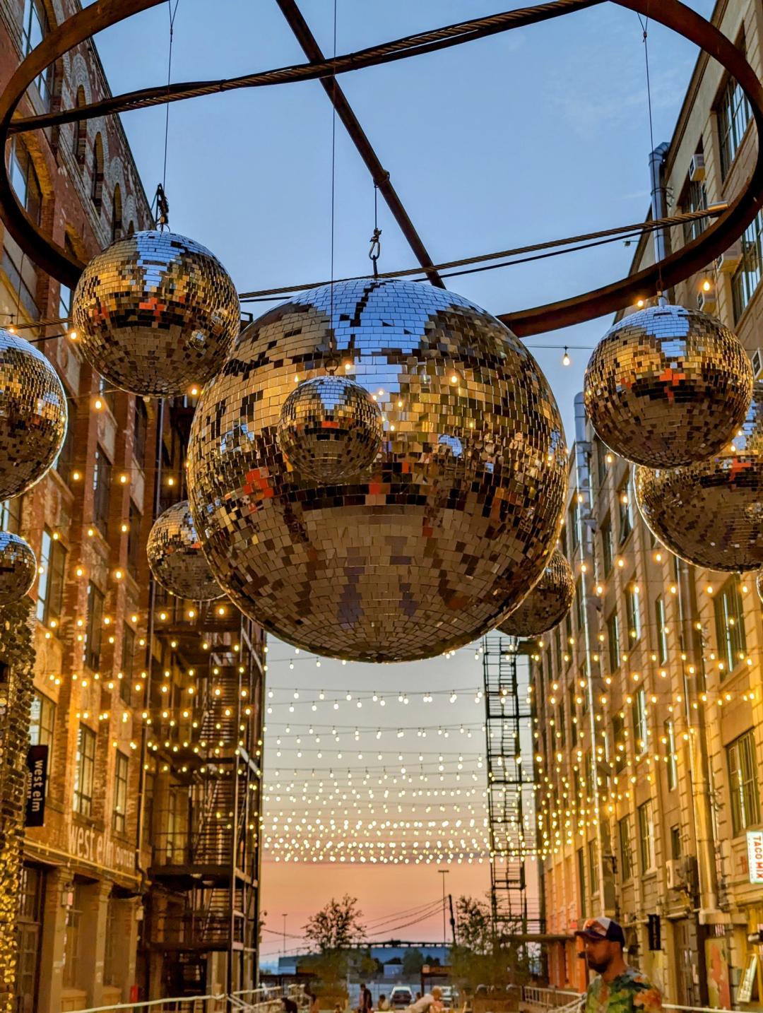 A photo of large outdoor disco balls at sunset taken in Brooklyn
