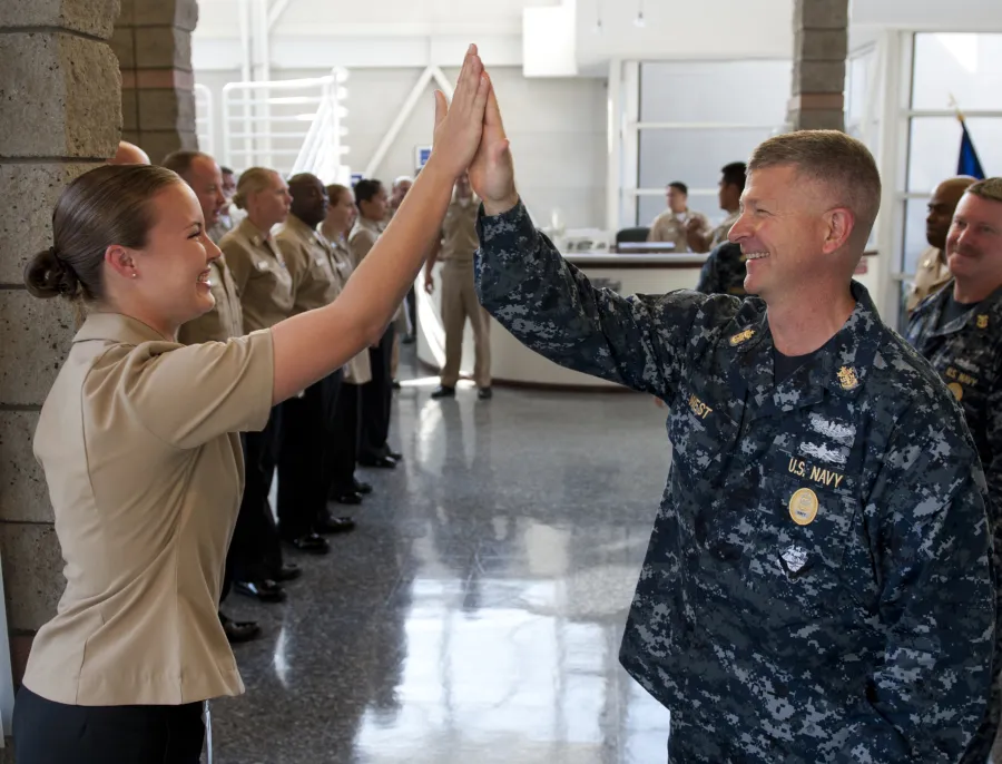 A high five between two US Navy Sailors. 