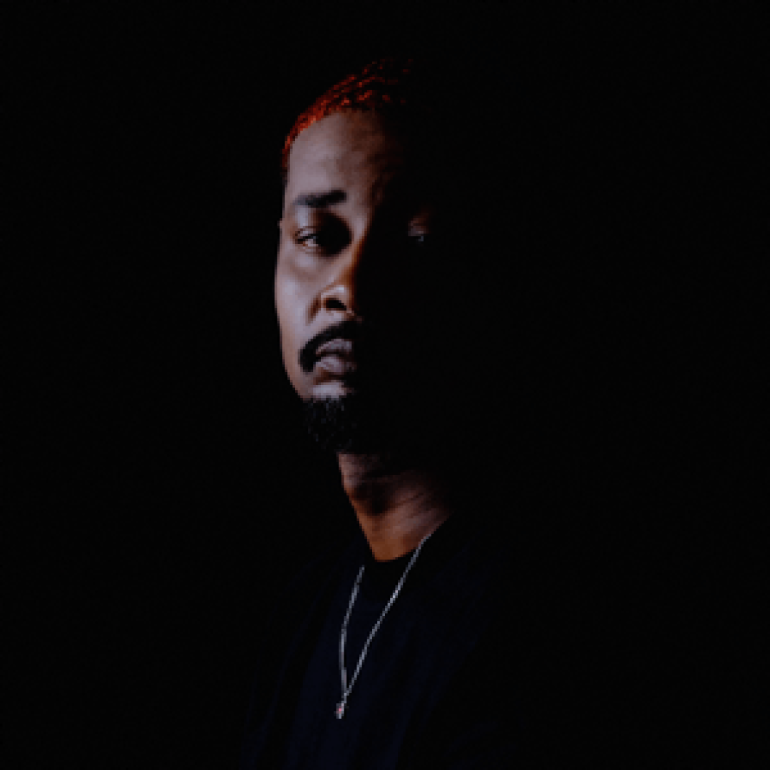 The album cover of Danny Brown's Quarantra showing Danny Brown looking somber in front of a dark background