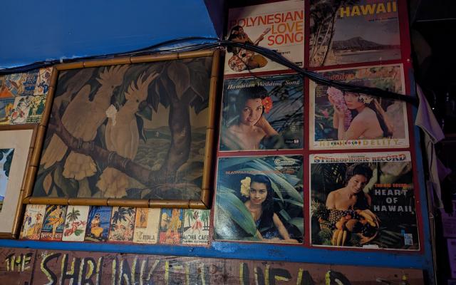 Tiki and Island style artwork on the wall of Otto's Shrunken Head Tiki Bar in NYC